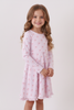 Young girl wearing a pink floral nightgown against a white background