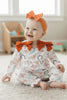 HOWDY" PRINTED GIRLS BABY ROMPER W/RUST SIDE BOWS.