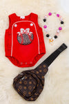 BASEBALL APPLICATION ON RED BABY ONESIE WITH RUFFLE TRIM.
