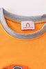 Orange character applique boy top